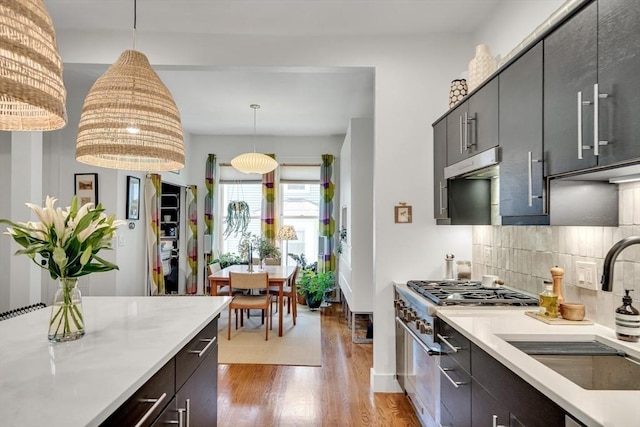 5 Mendell Way Unit 1, Boston, MA 02130 - kitchen featuring high end range, wood finished floors, light countertops, tasteful backsplash, and decorative light fixtures