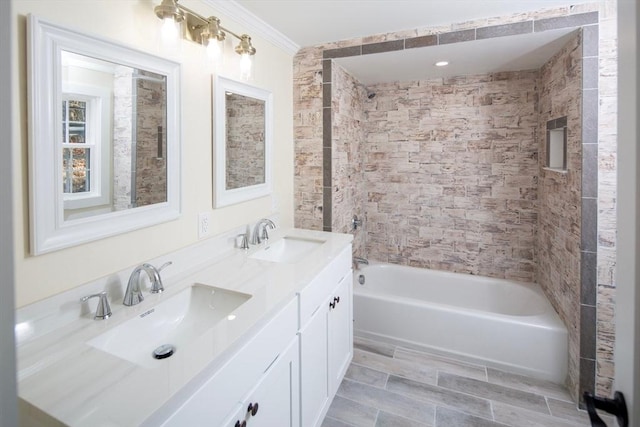 bathroom featuring double vanity, ornamental molding, washtub / shower combination, and a sink