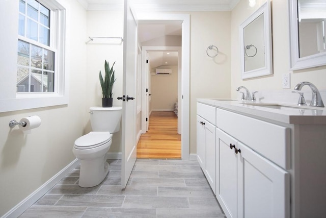 bathroom featuring toilet, a wall mounted AC, vanity, crown molding, and wood tiled floor