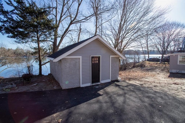 view of outdoor structure featuring an outbuilding and a water view