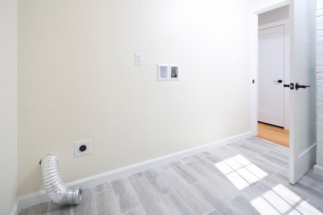 laundry area featuring laundry area, hookup for an electric dryer, light wood-style floors, and baseboards