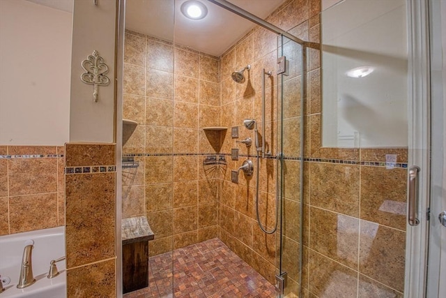 full bath with a stall shower and a bath