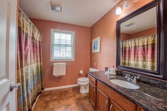 bathroom featuring vanity, toilet, baseboards, and a shower with shower curtain
