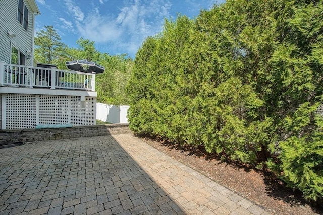 view of patio / terrace featuring a deck and fence