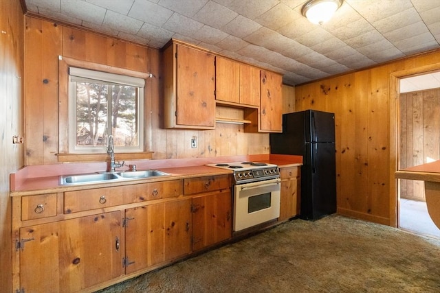 kitchen featuring white range with electric cooktop, dark carpet, black refrigerator, and sink