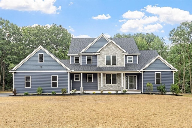 62 Bolton Rd Oakmont, Unit Oakmont, Westminster, MA 01473 - view of front of property featuring stone siding, roof with shingles, a front lawn, and a porch