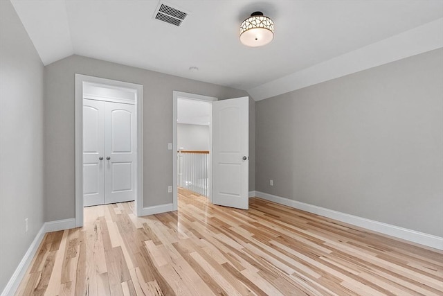62 Bolton Rd Oakmont, Unit Oakmont, Westminster, MA 01473 - unfurnished bedroom with lofted ceiling, light wood-style floors, and baseboards
