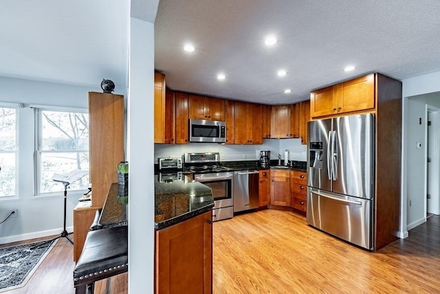 24 Shore Rd, Southwick, MA 01077 - kitchen featuring stainless steel appliances, light wood-style flooring, brown cabinets, recessed lighting, and a sink