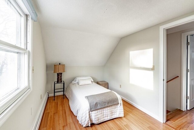 24 Shore Rd, Southwick, MA 01077 - bedroom with baseboard heating, wood finished floors, lofted ceiling, and baseboards