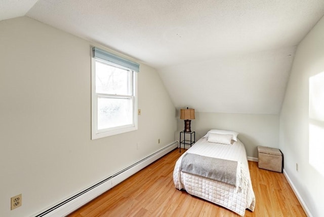 24 Shore Rd, Southwick, MA 01077 - bedroom featuring baseboard heating, lofted ceiling, wood finished floors, and baseboards