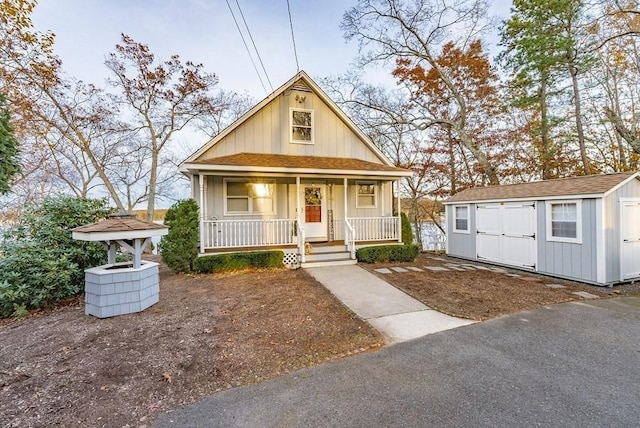 24 Shore Rd, Southwick, MA 01077 - bungalow-style house with a storage shed, a porch, an outdoor structure, and a shingled roof