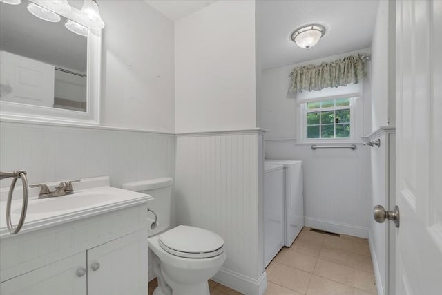 25 Liam Ln, Barnstable, MA 02632 - bathroom featuring separate washer and dryer, vanity, wainscoting, and tile patterned flooring