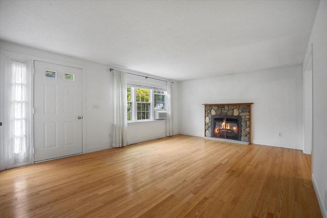 25 Liam Ln, Barnstable, MA 02632 - unfurnished living room with light wood-style floors, a fireplace, and cooling unit