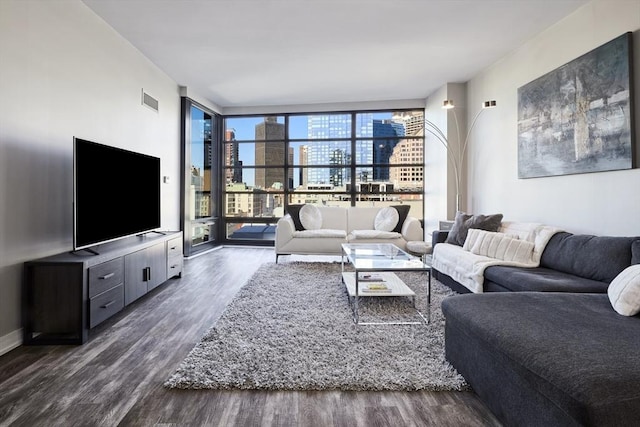 living area featuring baseboards, visible vents, floor to ceiling windows, and dark wood-style flooring