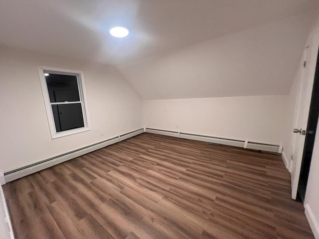 bonus room featuring dark hardwood / wood-style flooring, lofted ceiling, and baseboard heating