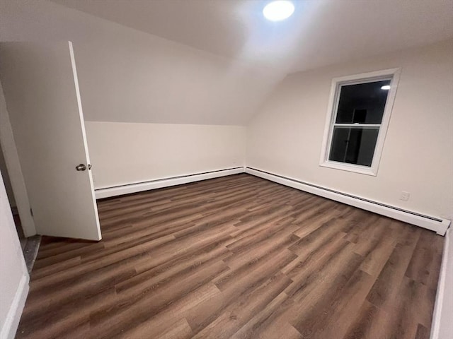 bonus room featuring dark hardwood / wood-style flooring, baseboard heating, and vaulted ceiling