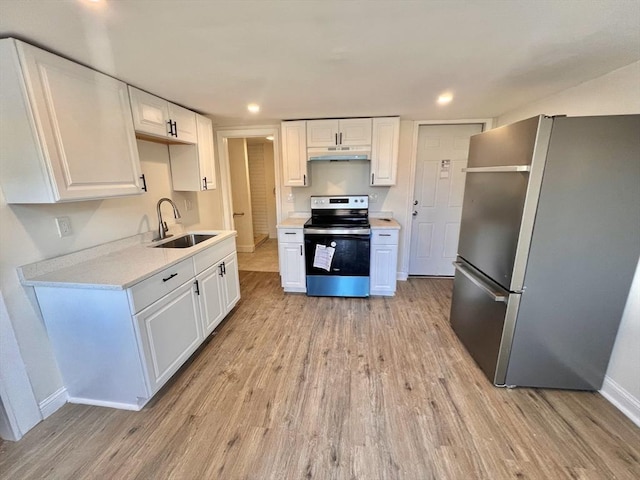 kitchen featuring light wood-type flooring, stainless steel appliances, white cabinetry, and sink