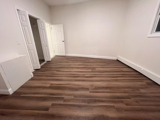 spare room with dark wood-type flooring