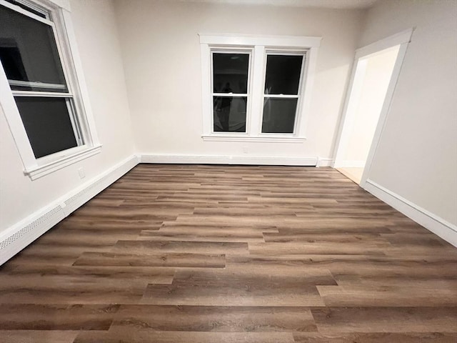 spare room with dark hardwood / wood-style flooring