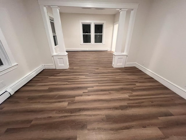 hallway with dark hardwood / wood-style flooring and a baseboard heating unit