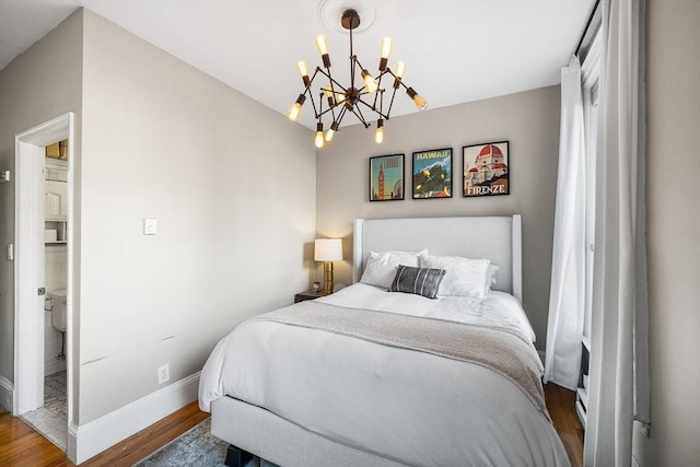 bedroom with baseboards, a notable chandelier, and wood finished floors