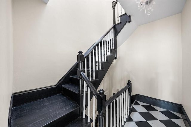 staircase featuring tile patterned floors and baseboards