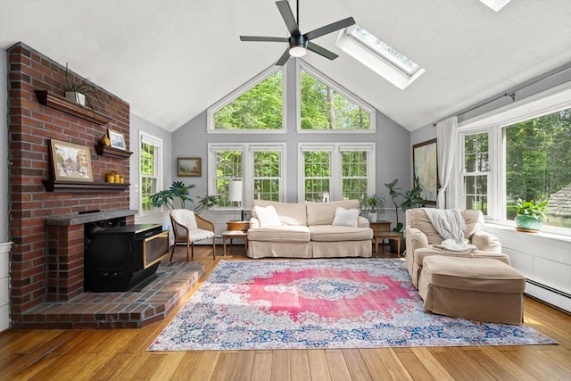 18 Arend Cir, Hanover, MA 02339 - living area featuring a ceiling fan, plenty of natural light, a wood stove, a skylight, and high vaulted ceiling
