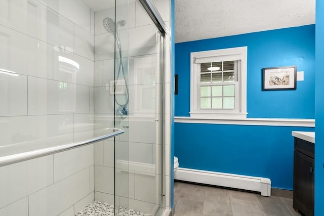 18 Arend Cir, Hanover, MA 02339 - bathroom with baseboard heating, a shower stall, toilet, vanity, and baseboards