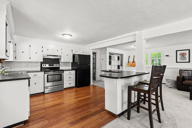 18 Arend Cir, Hanover, MA 02339 - kitchen featuring stainless steel electric range oven, freestanding refrigerator, under cabinet range hood, a sink, and dark countertops