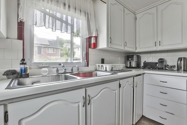 35 Linden Ter, Lynn, MA 01902 - kitchen featuring a sink, light countertops, white cabinetry, and tasteful backsplash