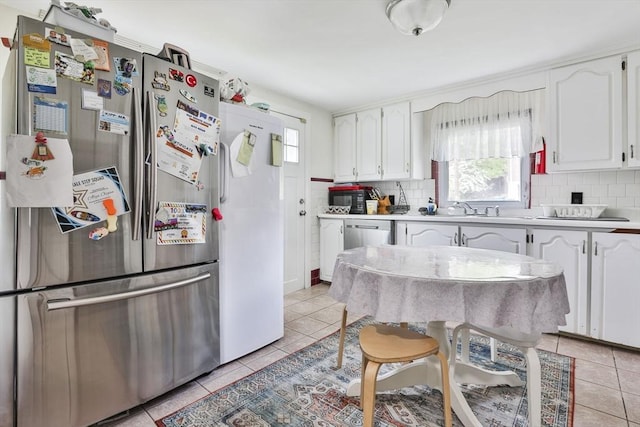 35 Linden Ter, Lynn, MA 01902 - kitchen with freestanding refrigerator, white cabinetry, and light tile patterned flooring