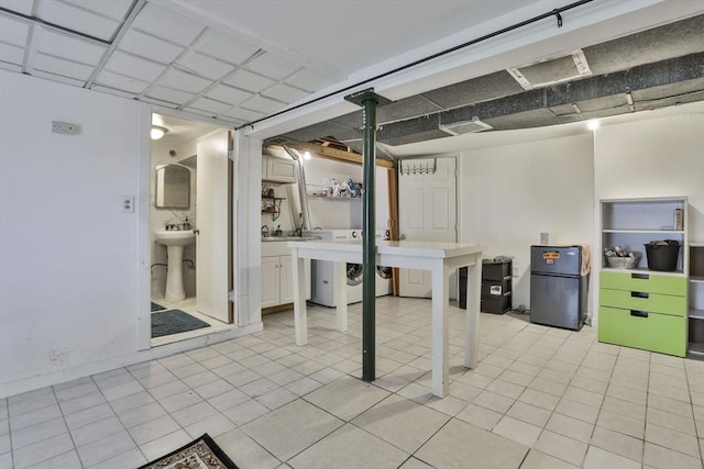 35 Linden Ter, Lynn, MA 01902 - below grade area featuring freestanding refrigerator, a sink, and washer / dryer