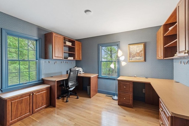 office area featuring light wood-style floors, plenty of natural light, wallpapered walls, and baseboards