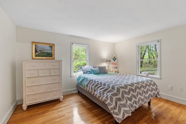 bedroom featuring baseboards and light wood-style flooring