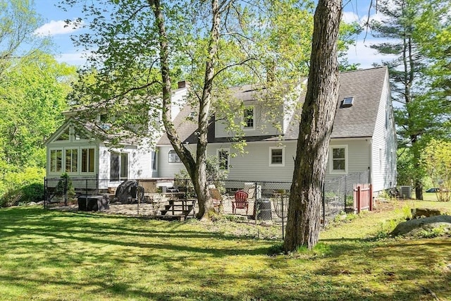 rear view of house featuring a chimney