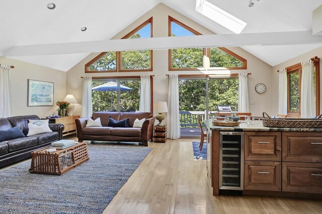 10 Eagles Nest, Edgartown, MA 02539 - living room featuring wine cooler, a skylight, light wood-type flooring, high vaulted ceiling, and beam ceiling
