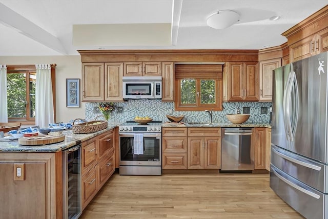 10 Eagles Nest, Edgartown, MA 02539 - kitchen with appliances with stainless steel finishes, wine cooler, light stone counters, and a peninsula
