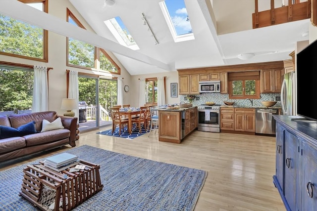 10 Eagles Nest, Edgartown, MA 02539 - living room featuring high vaulted ceiling, rail lighting, a skylight, and light wood-style flooring