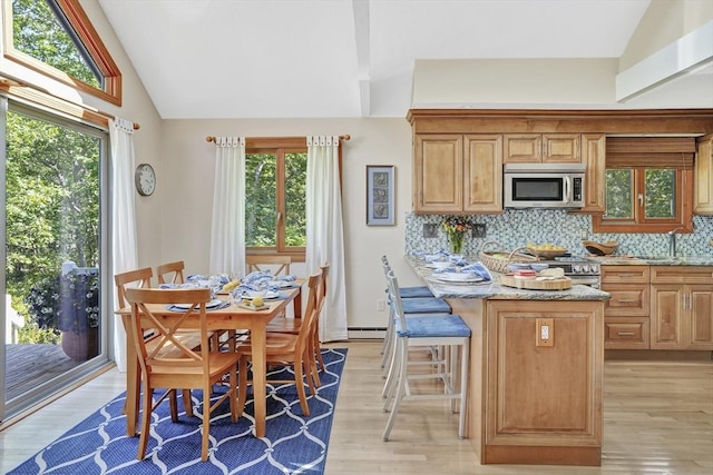 10 Eagles Nest, Edgartown, MA 02539 - kitchen featuring appliances with stainless steel finishes, light wood finished floors, decorative backsplash, healthy amount of natural light, and high vaulted ceiling