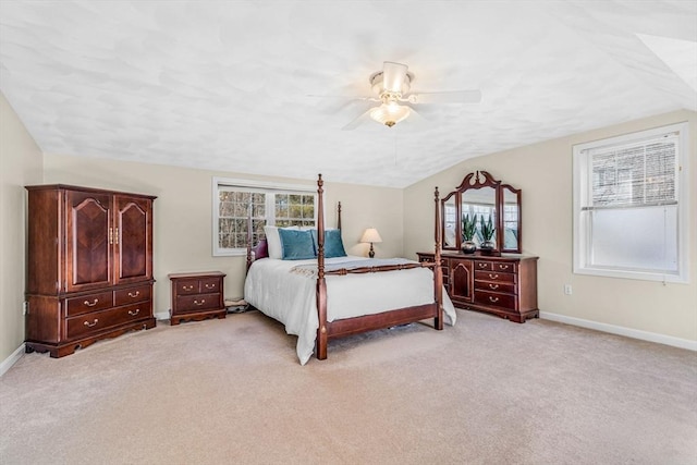 bedroom with ceiling fan, lofted ceiling, baseboards, and light carpet