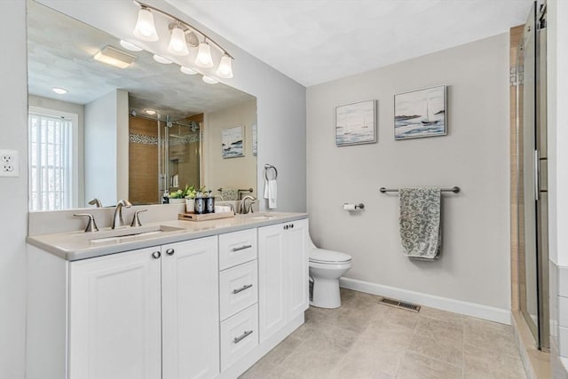 bathroom with visible vents, a stall shower, baseboards, and a sink