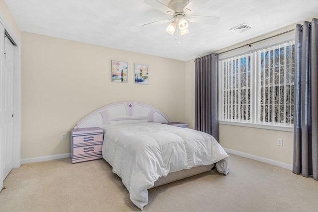 bedroom with visible vents, baseboards, carpet, a closet, and a ceiling fan