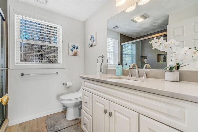 full bathroom with vanity, toilet, visible vents, and a stall shower