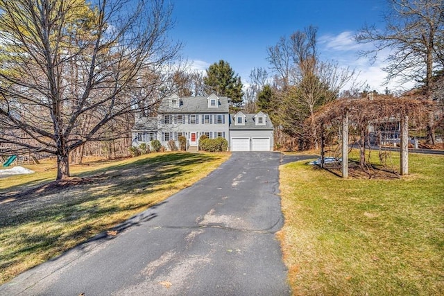 view of front of home with a garage and a front lawn