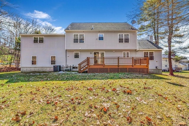 rear view of house featuring a yard, central AC, and a deck