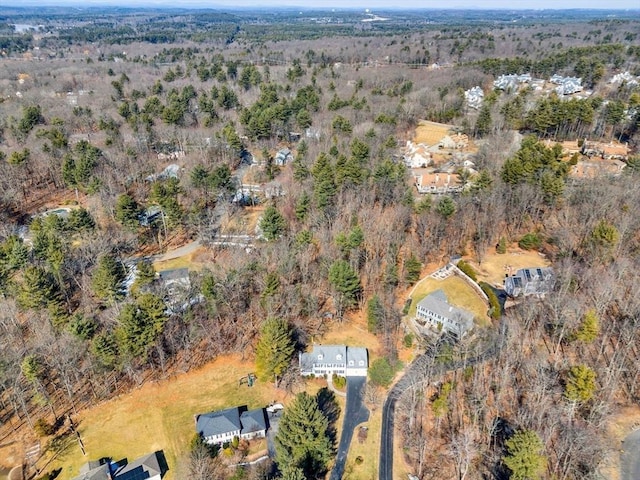 birds eye view of property featuring a forest view