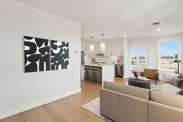 301 Border Unit 409, Boston, MA 02128 - living area featuring light wood finished floors, baseboards, and recessed lighting