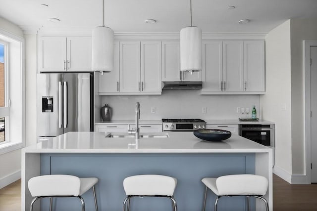 301 Border Unit 409, Boston, MA 02128 - kitchen featuring stainless steel fridge with ice dispenser, wall oven, a sink, under cabinet range hood, and a breakfast bar