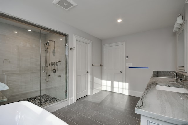 bathroom with walk in shower, tile floors, and dual bowl vanity