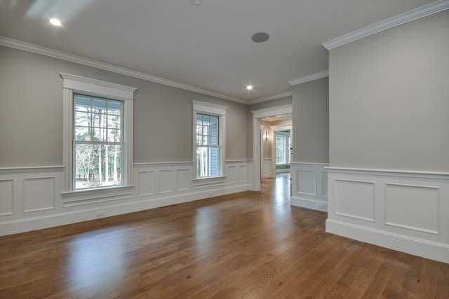 empty room with dark hardwood / wood-style floors and ornamental molding